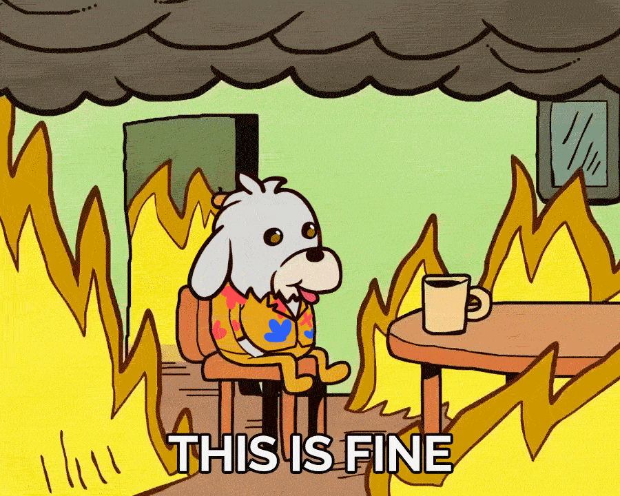 Cartoon dog sitting calmly in a room engulfed in flames, captioned "This is fine."