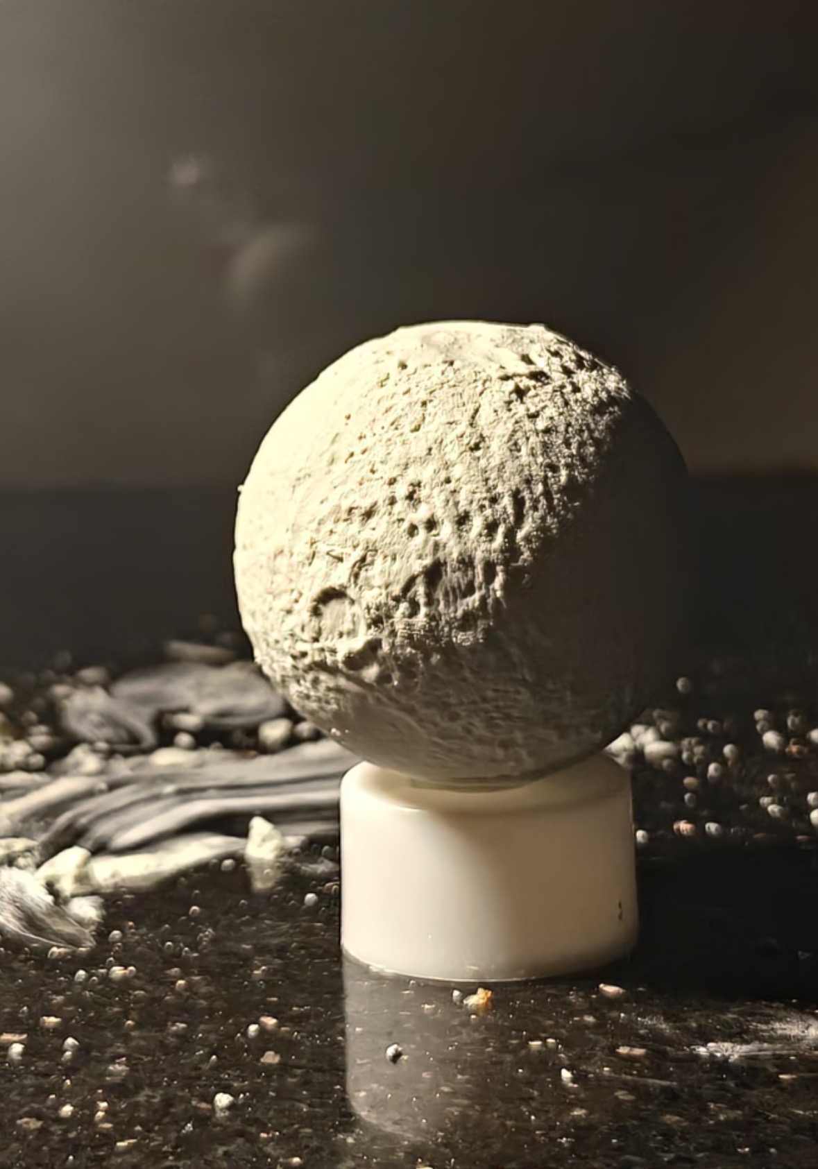Textured plaster sphere cast by @voxelweave on a pedestal stand
