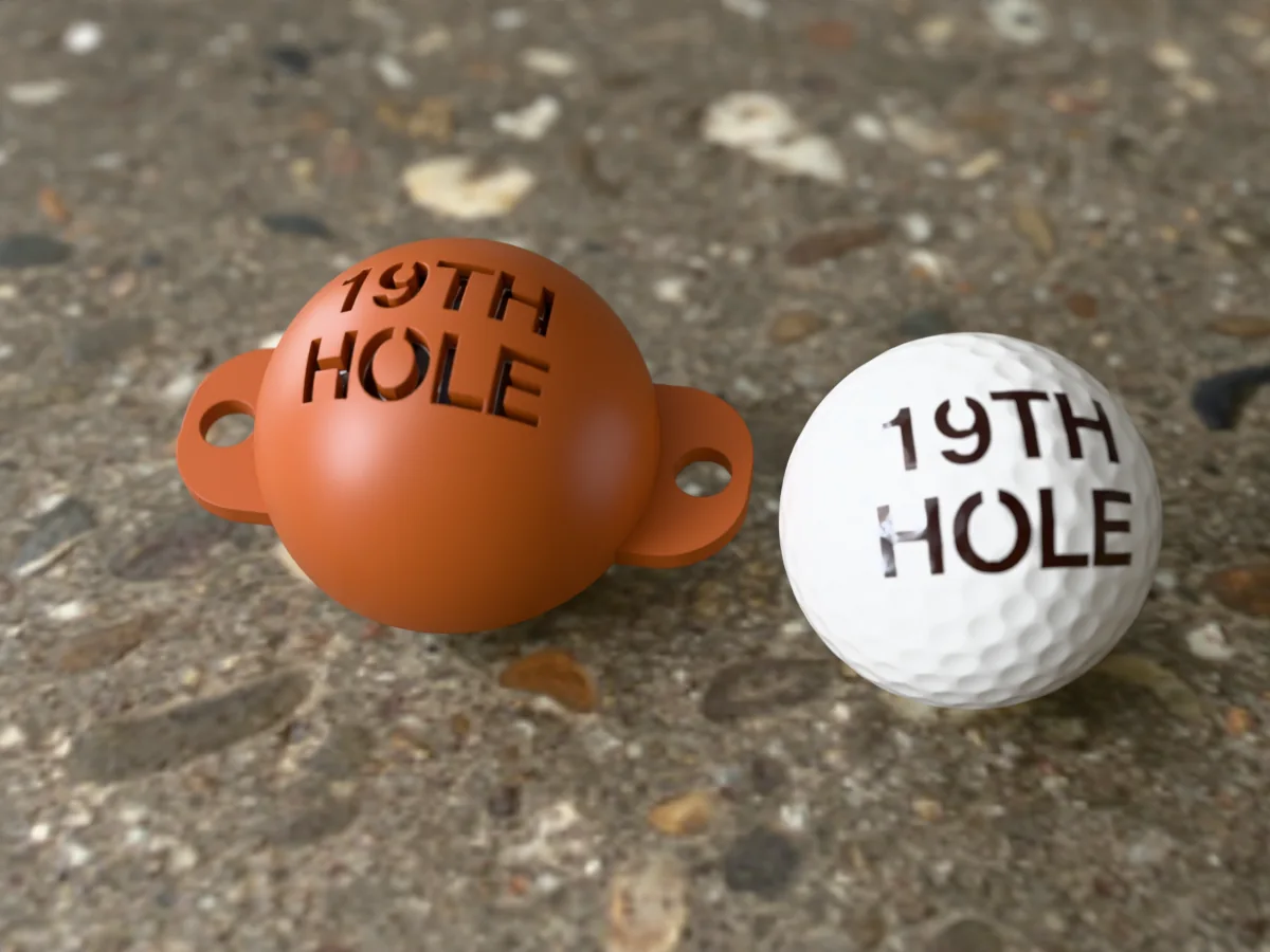 3D render of a brown 3D-printed golf ball stencil with 19TH HOLE cut through it, sitting on a golf ball, next to a ball marked with 19TH HOLE in dark brown