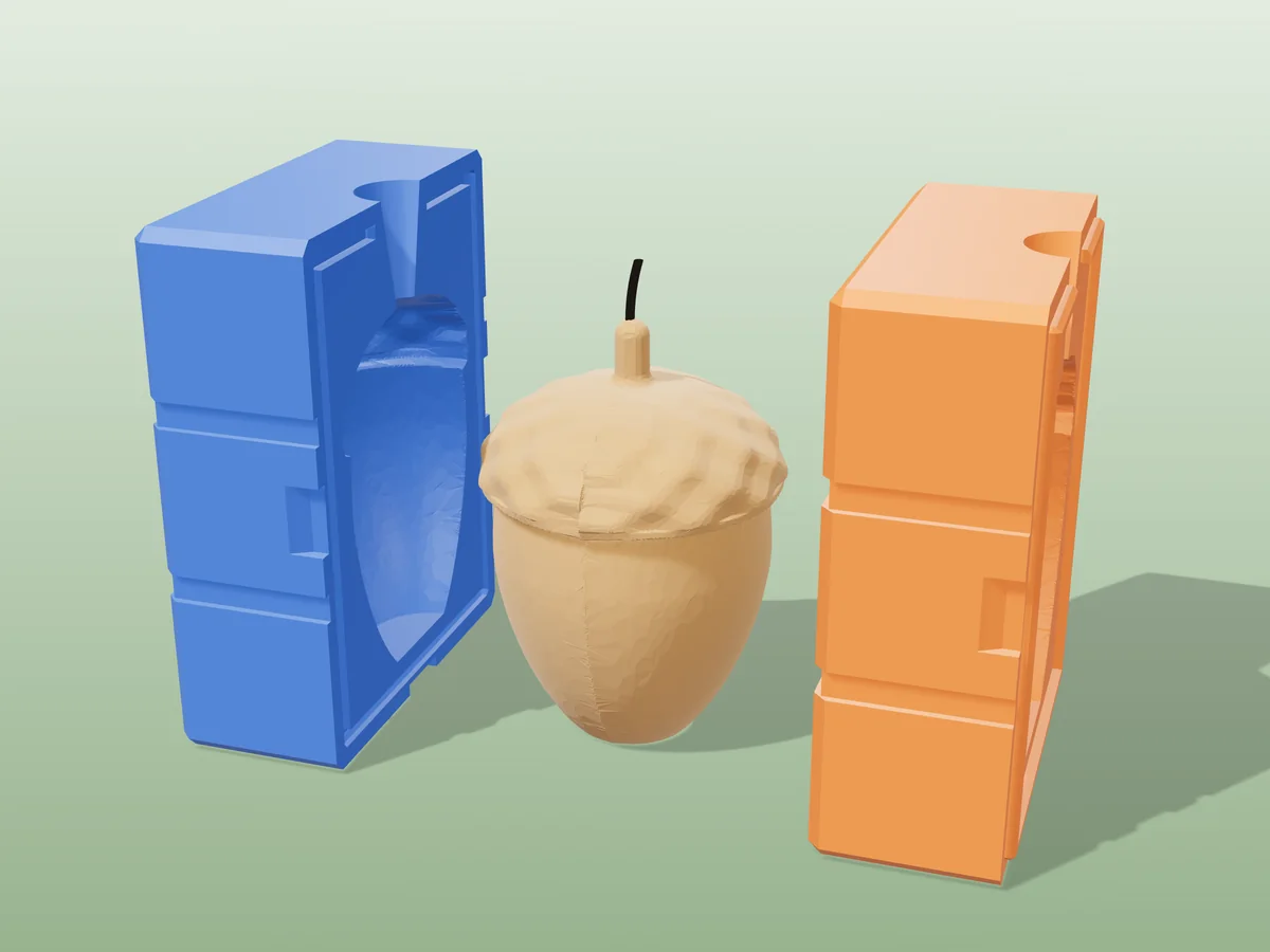 3D render of a caramel acorn candle with a textured cup and stem between the two printed halves of its rigid blue and orange mold