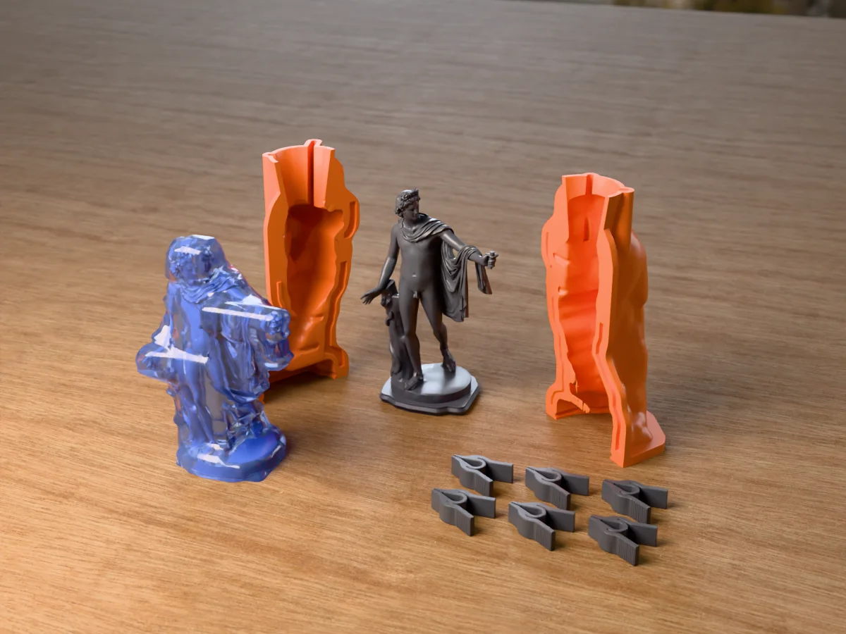 3D render of the Apollo Belvedere master on its printed charcoal base between the two orange hugging-shell halves, with the six printed clamps and the cured translucent blue silicone mold in front