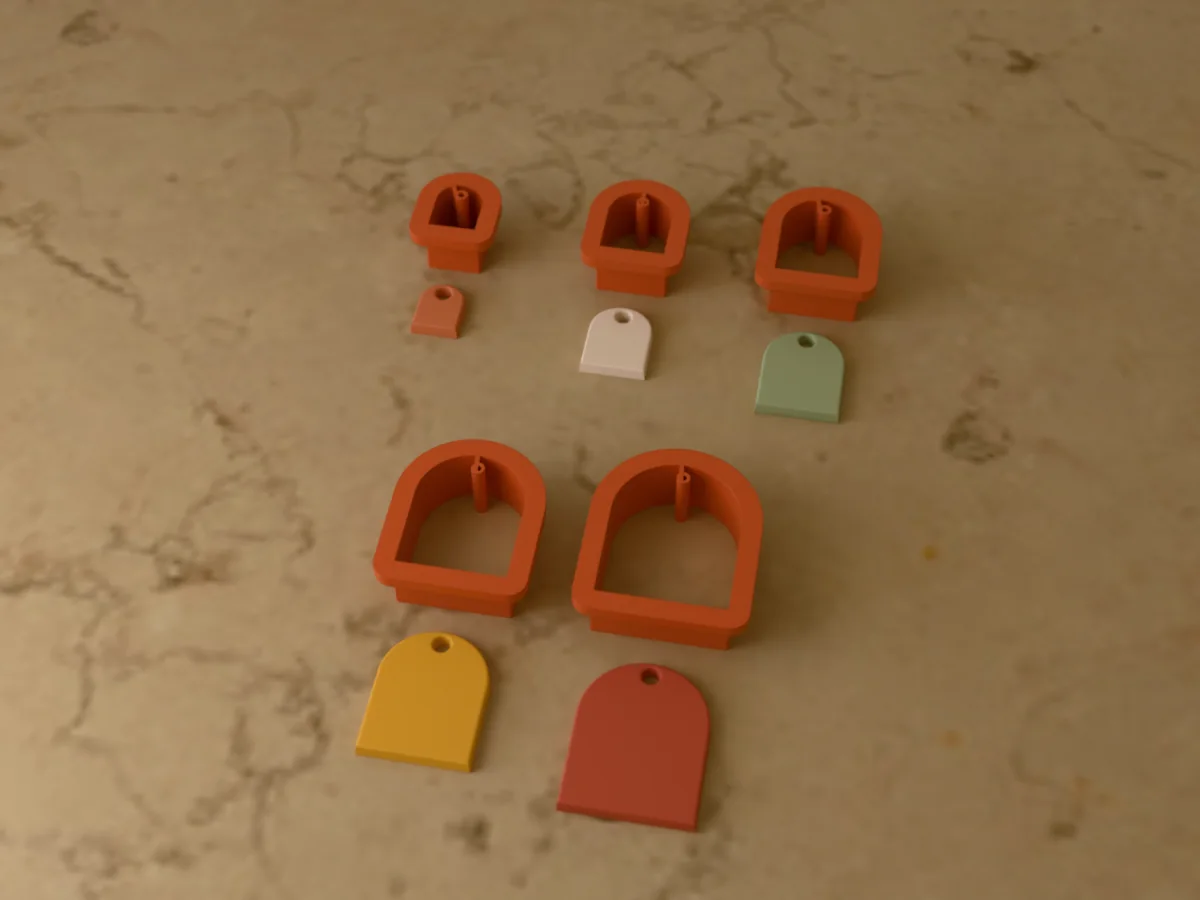 3D render of five 3D-printed terracotta polymer clay earring cutters (arch 15 mm, arch 20 mm, arch 25 mm, arch 30 mm and arch 35 mm) with the clay earring pieces they cut in front