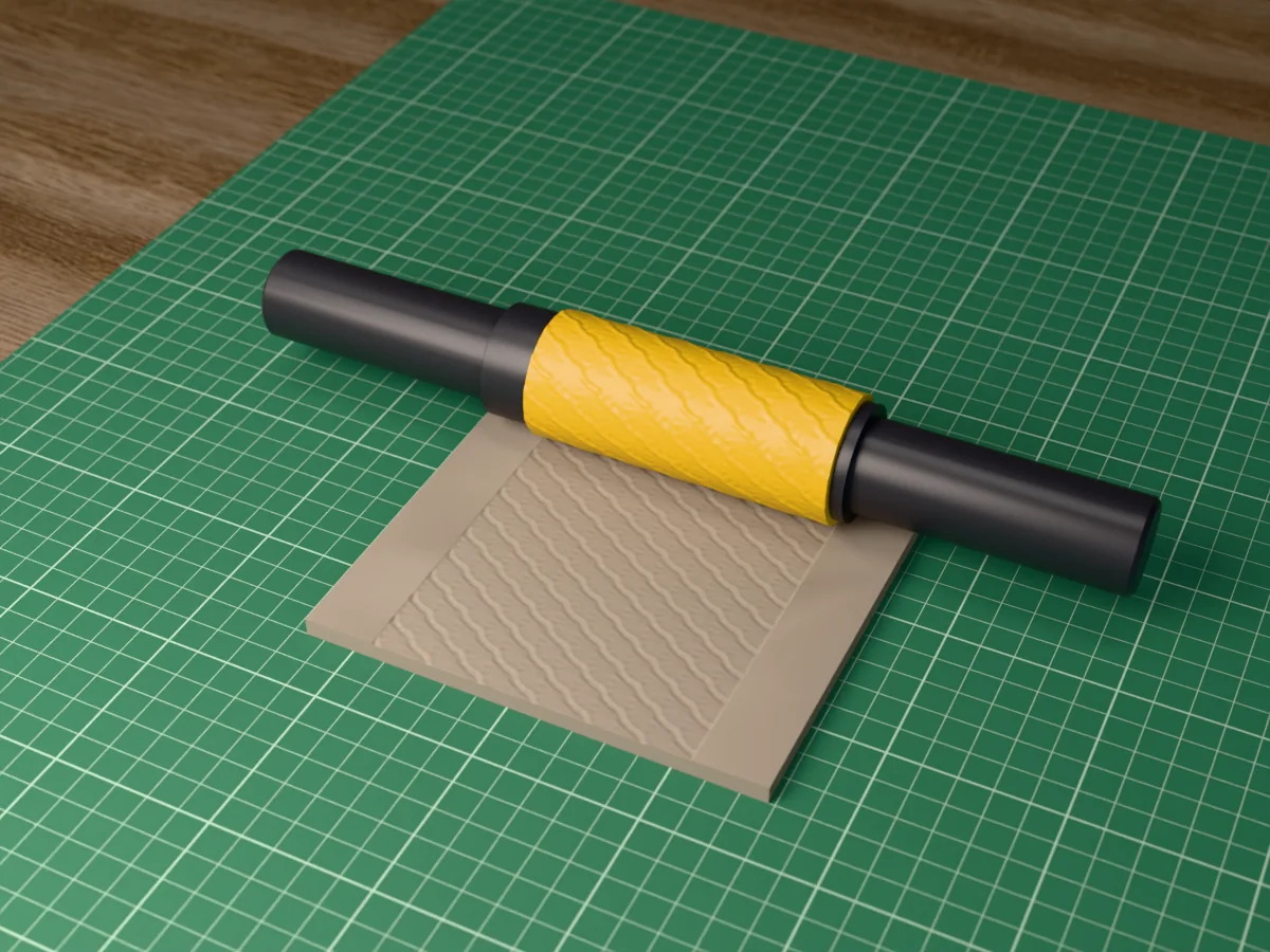 3D render of the printed art deco fan textured rolling pin, its patterned sleeve between two dark handles, resting on a slab of clay it has pressed with art deco fans