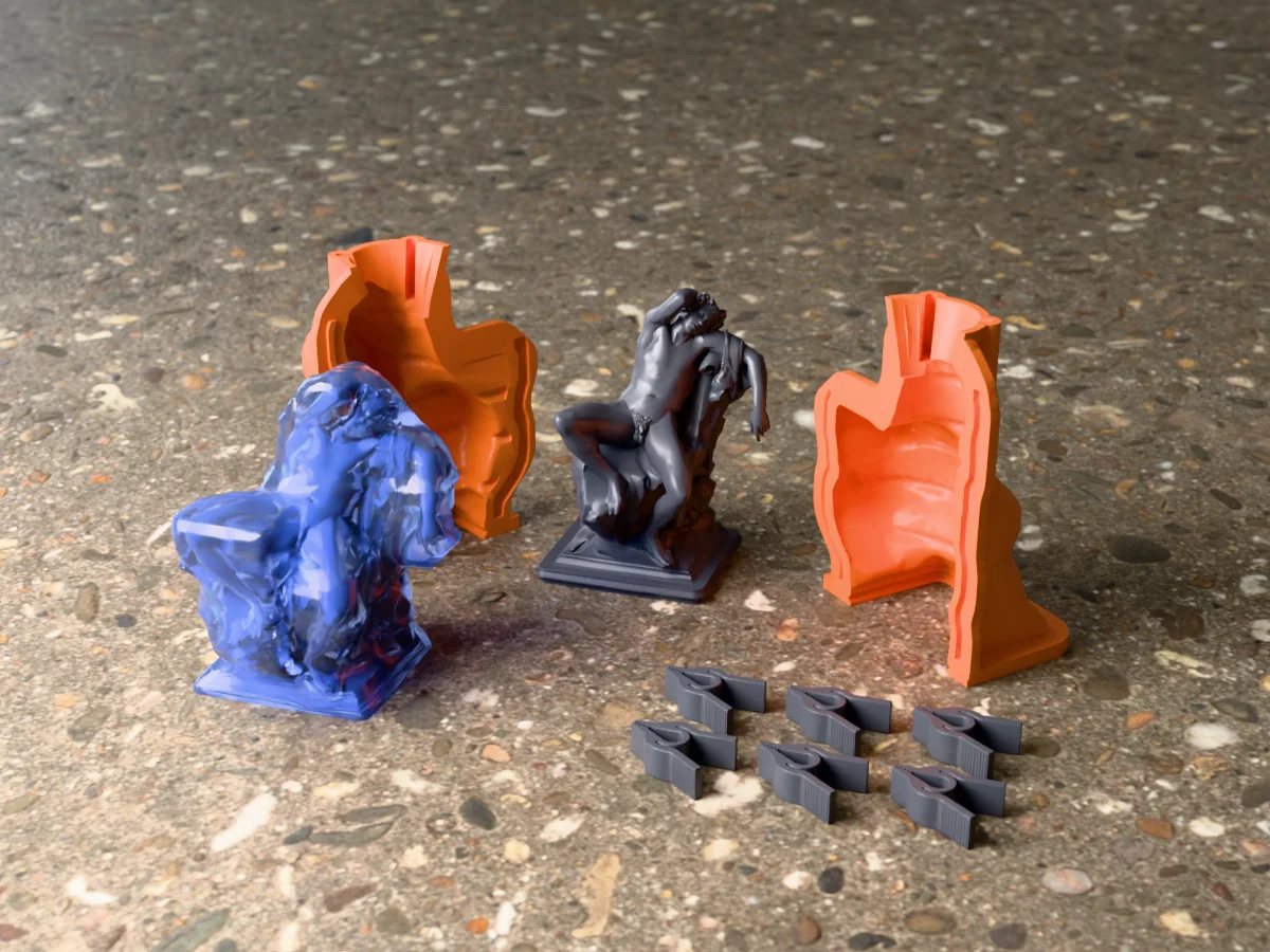3D render of the Barberini Faun master on its printed charcoal base between the two orange hugging-shell halves, with the six printed clamps and the cured translucent blue silicone mold in front