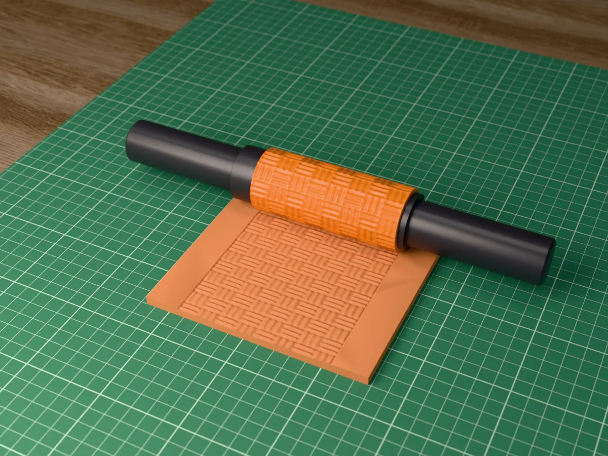 3D render of the printed basket weave textured rolling pin, its patterned sleeve between two dark handles, resting on a slab of clay it has pressed with a basket weave