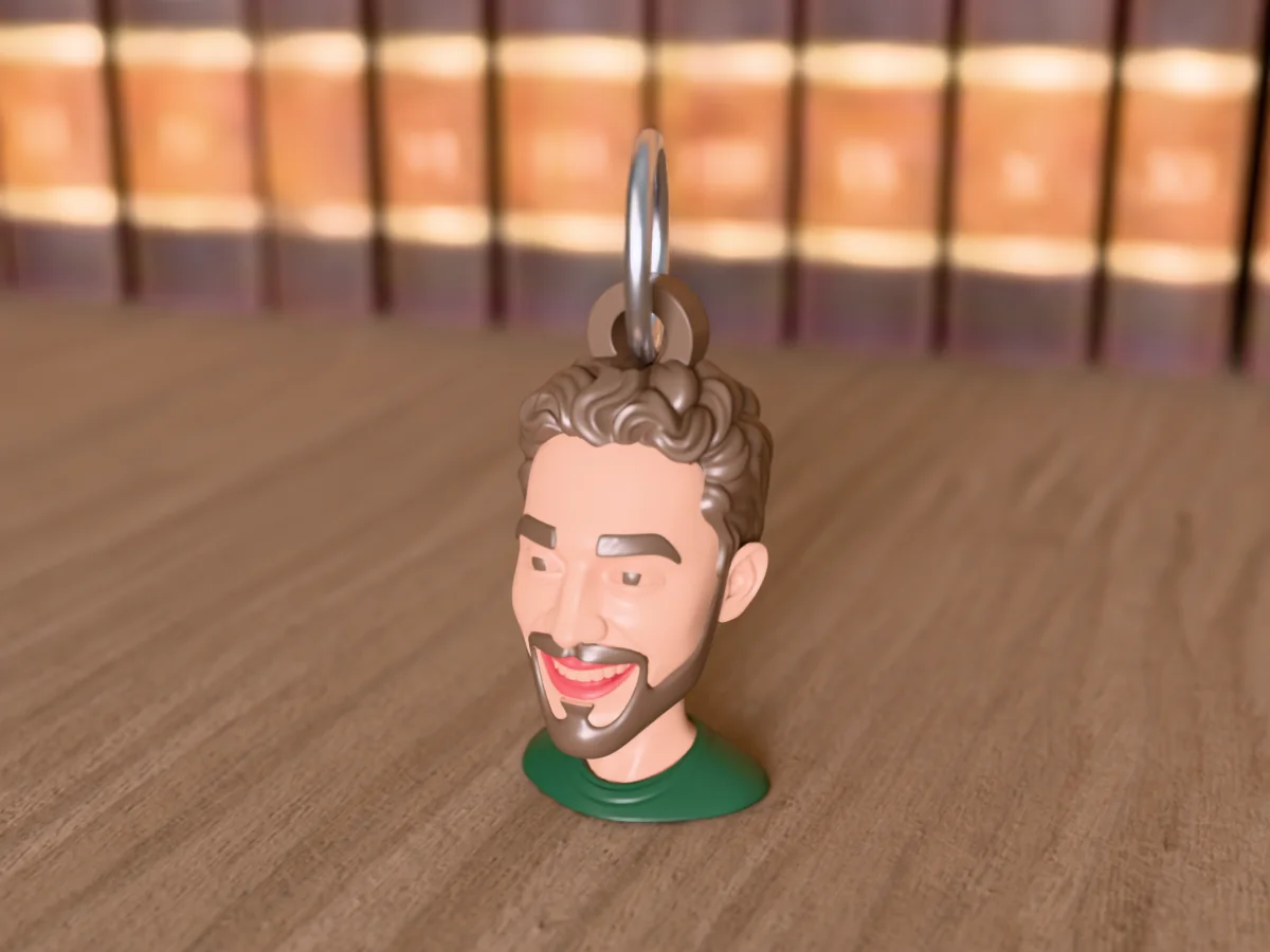 3D render of a 3D-printed head keychain of a smiling guy with curly brown hair and a full beard, painted in 5 colours, on a table