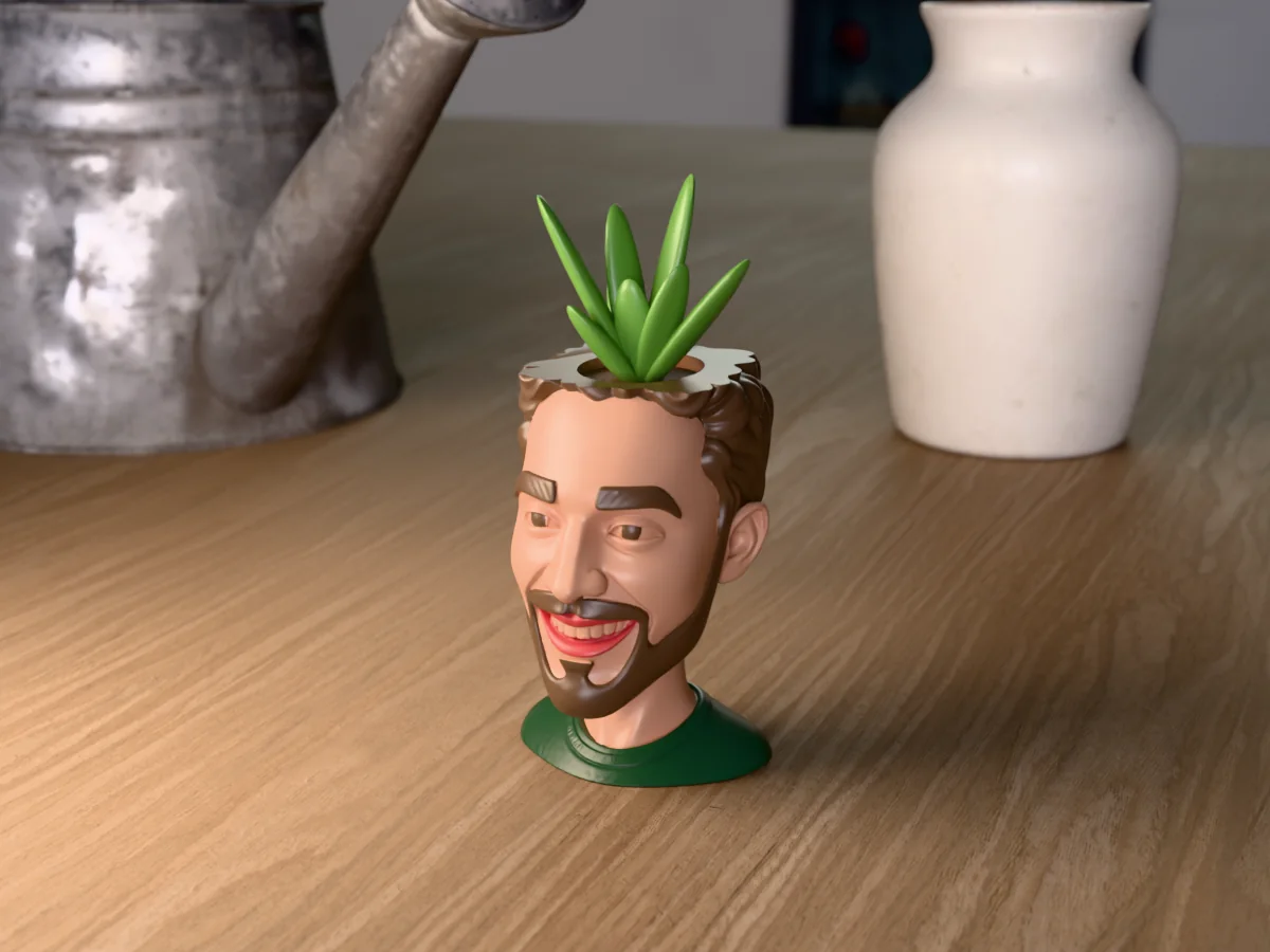 3D render of a 3D-printed head planter of a smiling guy with curly brown hair and a full beard, painted in 5 colours, on a table