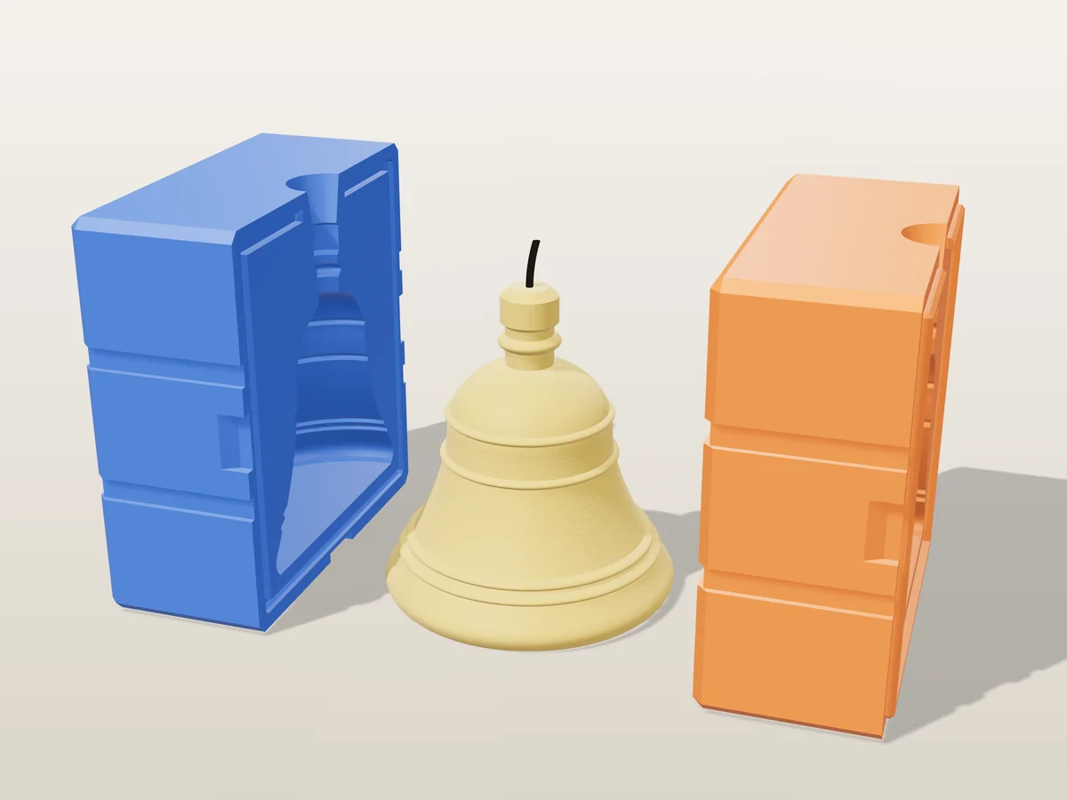 3D render of a gold Christmas bell candle with raised rings and a crown knob between the two printed halves of its rigid orange and blue mold