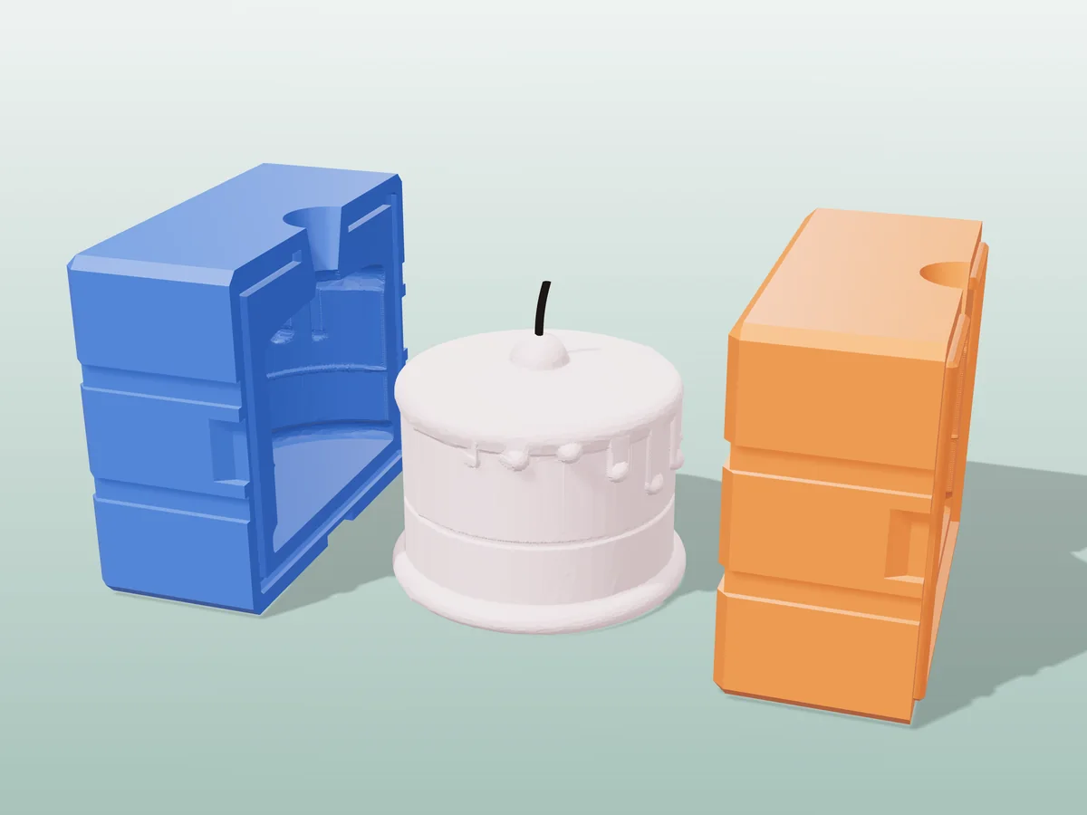 3D render of a pink birthday cake candle with frosting drips and a cherry between the two printed halves of its rigid blue and orange mold