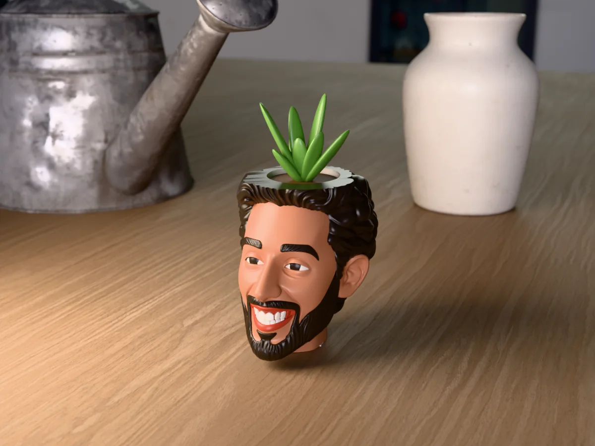 3D render of a 3D-printed head planter of a guy with short black hair and a trimmed black beard, painted in 5 colours, on a table