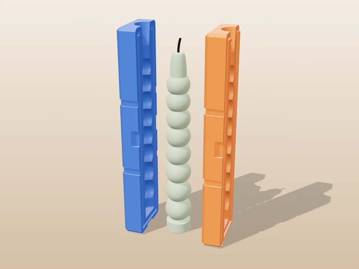 3D render of a sage green bobbin taper candle of stacked beads between the two tall printed halves of its rigid blue and orange mold