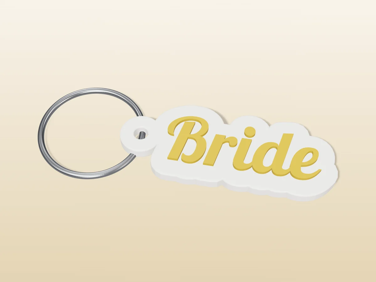 3D render of a white and gold 3D-printed Bride keychain with a steel split ring through its hole