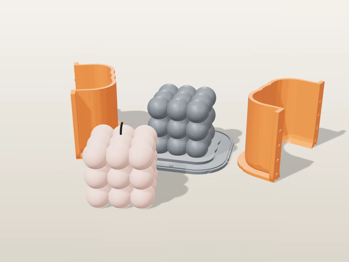 3D render of a pale pink 27-bubble cube candle in front of its printed grey base and orange hugging shell halves