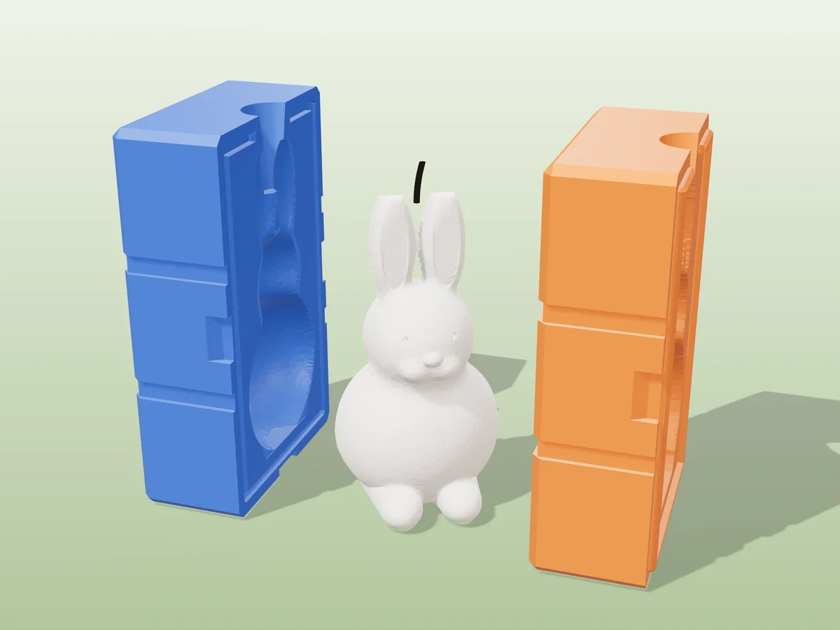 3D render of a white sitting bunny candle with tall ears between the two printed halves of its rigid blue and orange mold