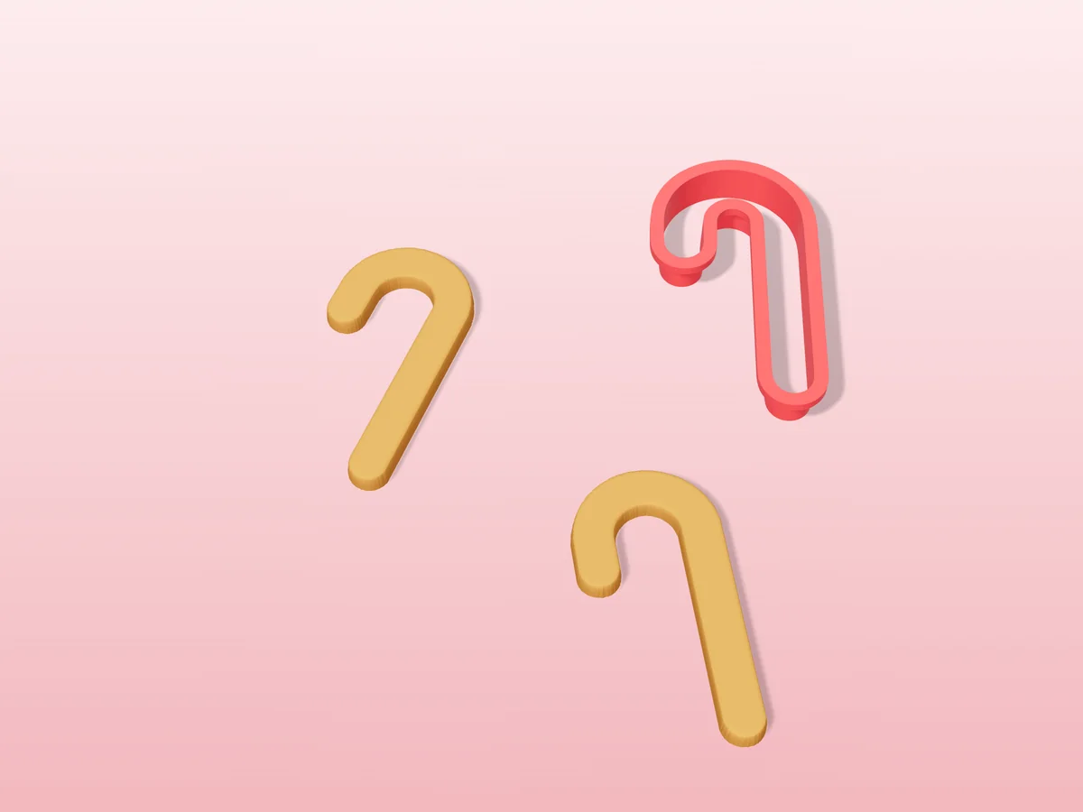 3D render of a red 3D-printed candy cane cookie cutter next to two golden baked cookies in the same shape