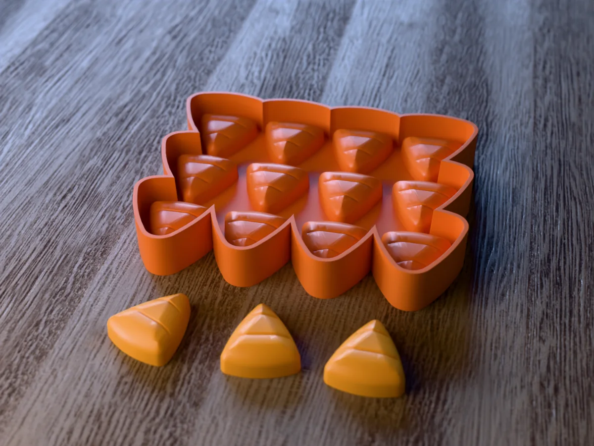 3D render of the printed caster for a twelve-cavity silicone candy corn wax melt tray, with three candy corn wax melts in front
