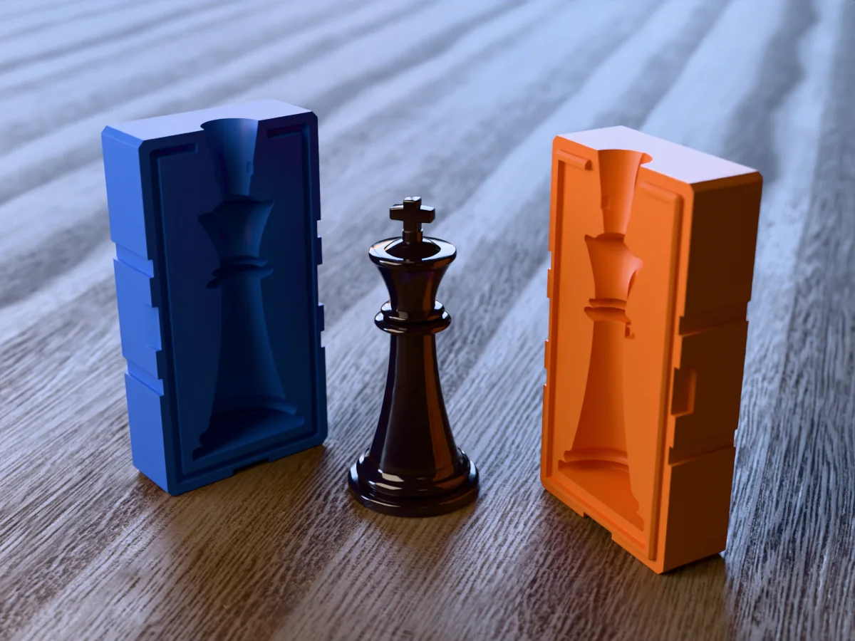 3D render of a glossy black resin chess king with its cross between the two printed halves of its rigid orange and blue mold