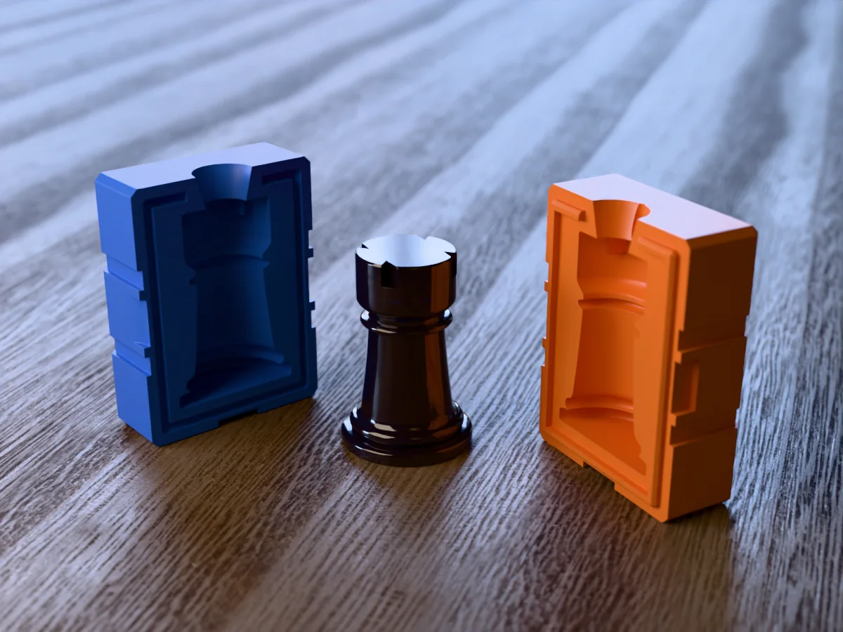 3D render of a glossy black resin chess rook with its crenellated turret between the two printed halves of its rigid orange and blue mold