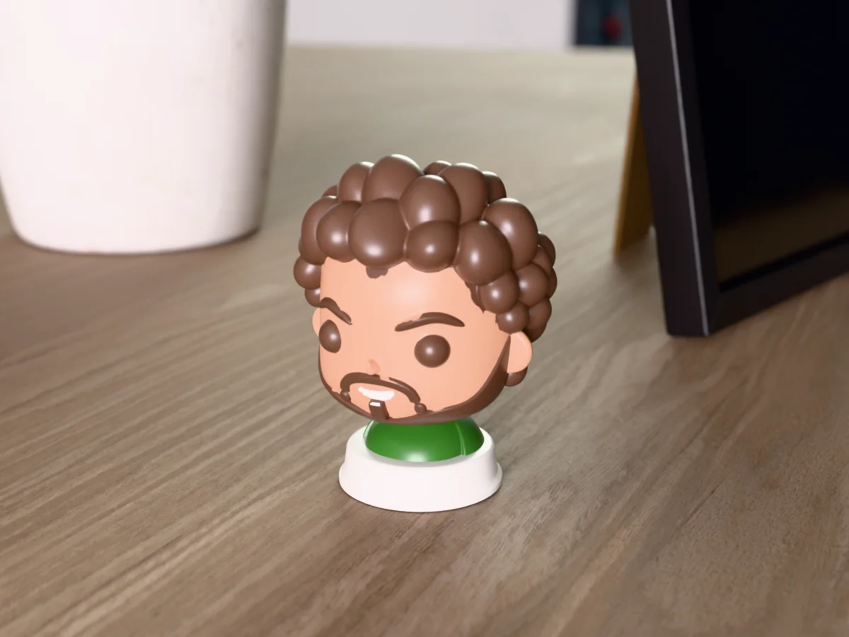 3D render of a 3D-printed bust of a big-eyed chibi version of a bearded guy with curly hair, painted in 6 colours, on a table