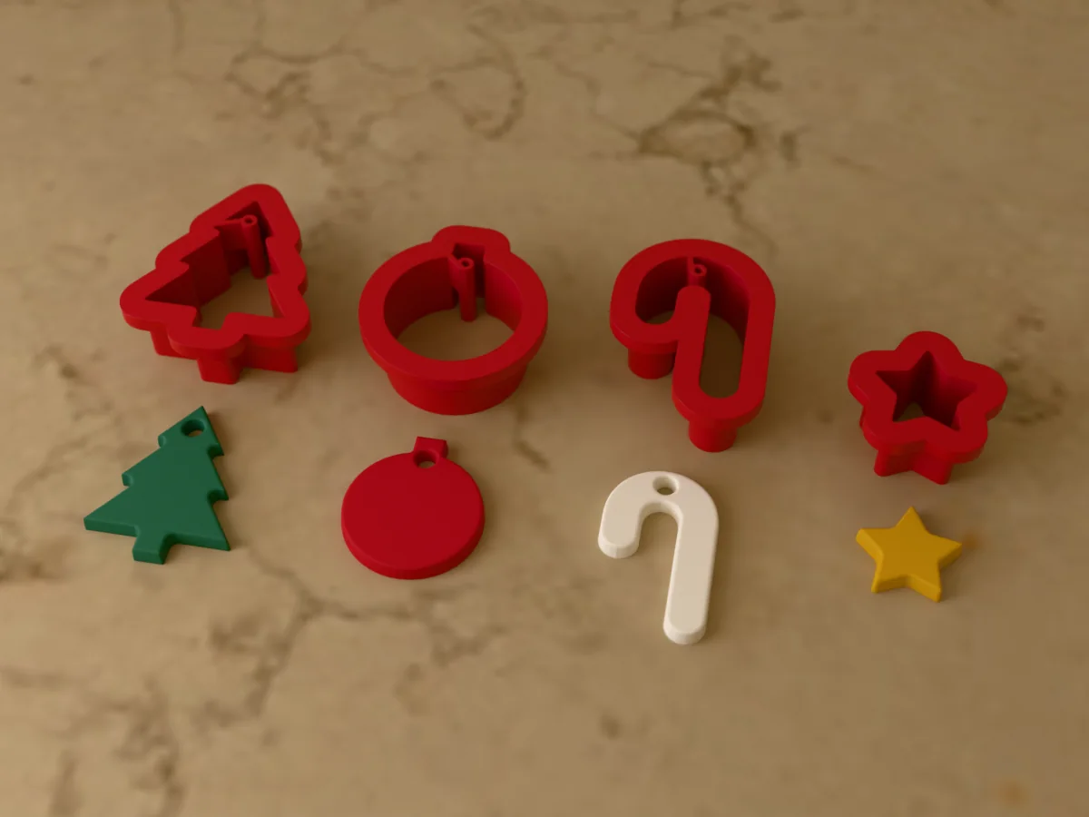 3D render of four 3D-printed red polymer clay earring cutters (christmas tree 32 mm, bauble 28 mm, candy cane 32 mm and star 18 mm) with the clay earring pieces they cut in front