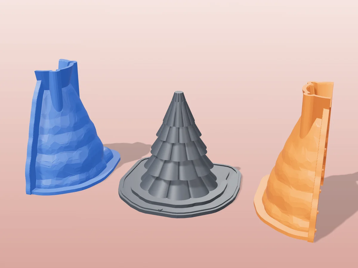 3D render of the layered Christmas tree master fused on its printed charcoal base, between the orange and blue hugging shell halves
