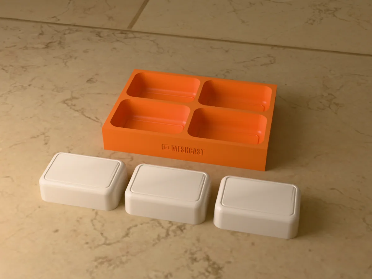 3D render of a printed tray with four rectangular soap bar cavities, with three cream soap bars with an engraved frame beside it
