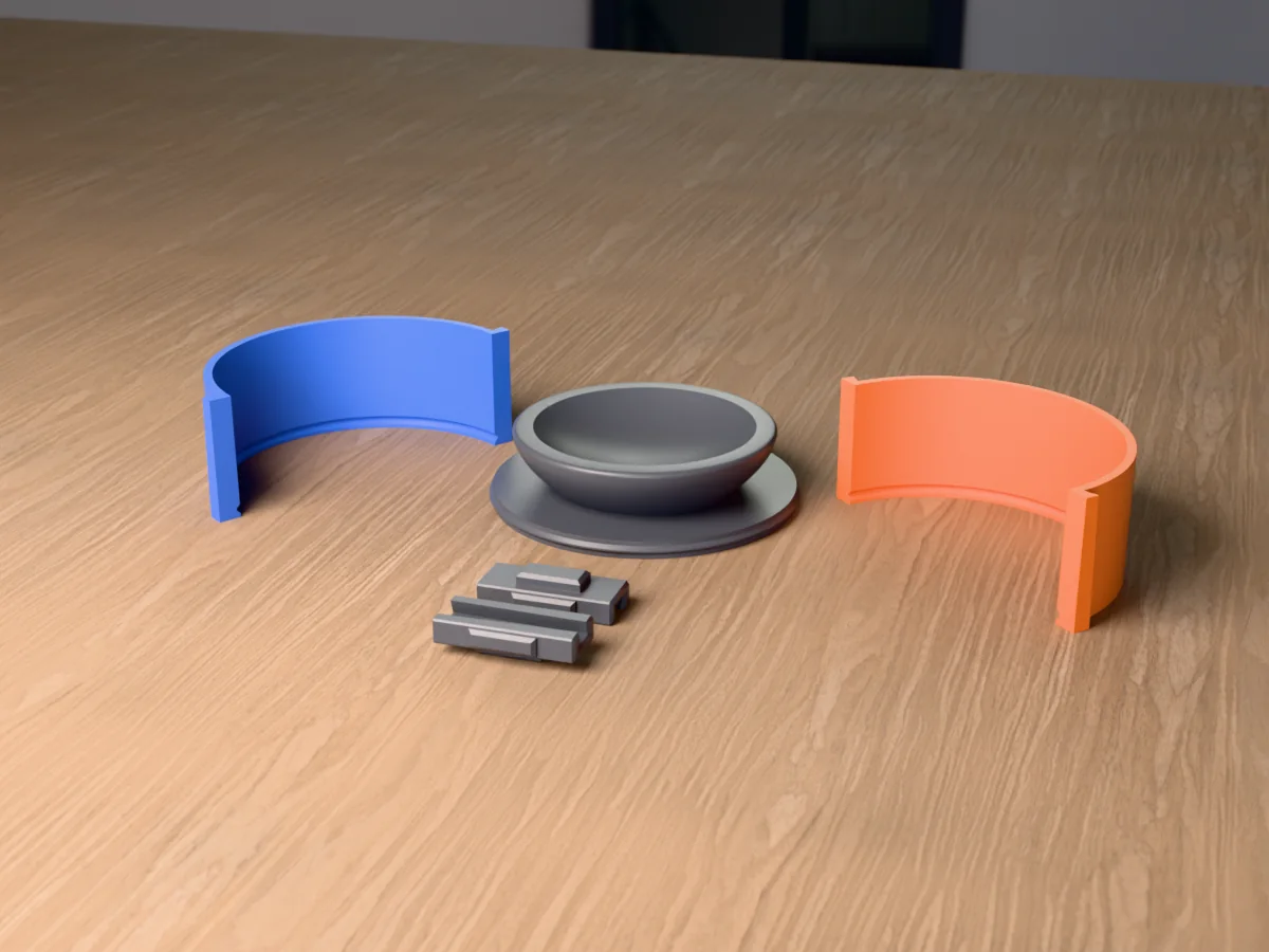 3D render of the bird bath master fused on its printed round base, between the blue and orange curved walls, with the two clamps in front