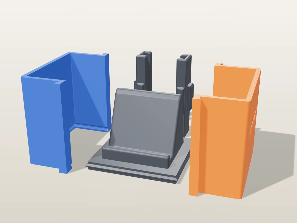 3D render of the wedge-shaped phone stand master fused on its printed charcoal base, between the orange and blue walls, with the charcoal clamps behind