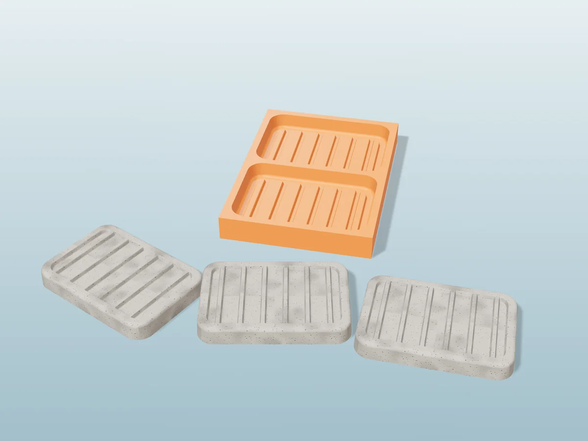 3D render of a printed orange tray with two soap dish cavities, and three grey concrete soap dishes with drain ridges in front