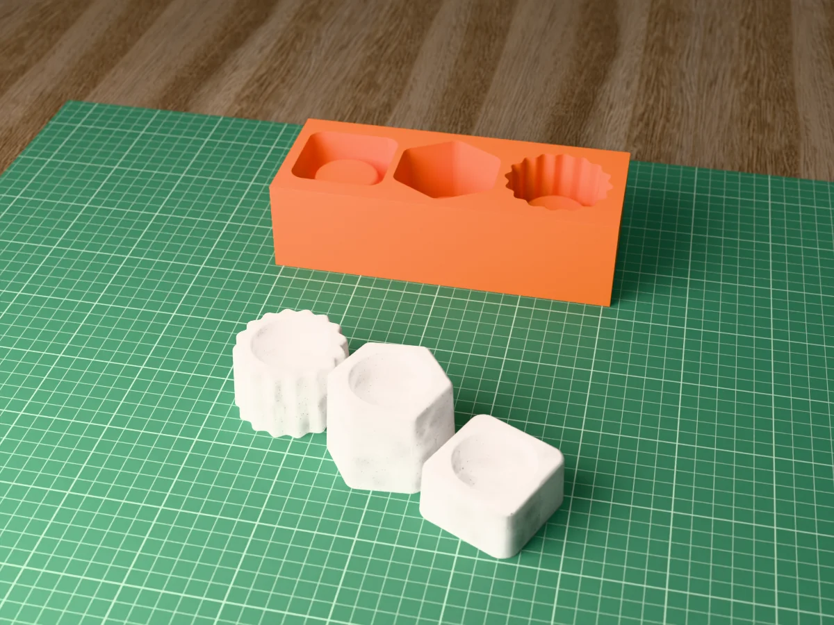 3D render of a printed orange tray with three tealight holder cavities, square, hexagon and scalloped, with the three grey concrete holders in front