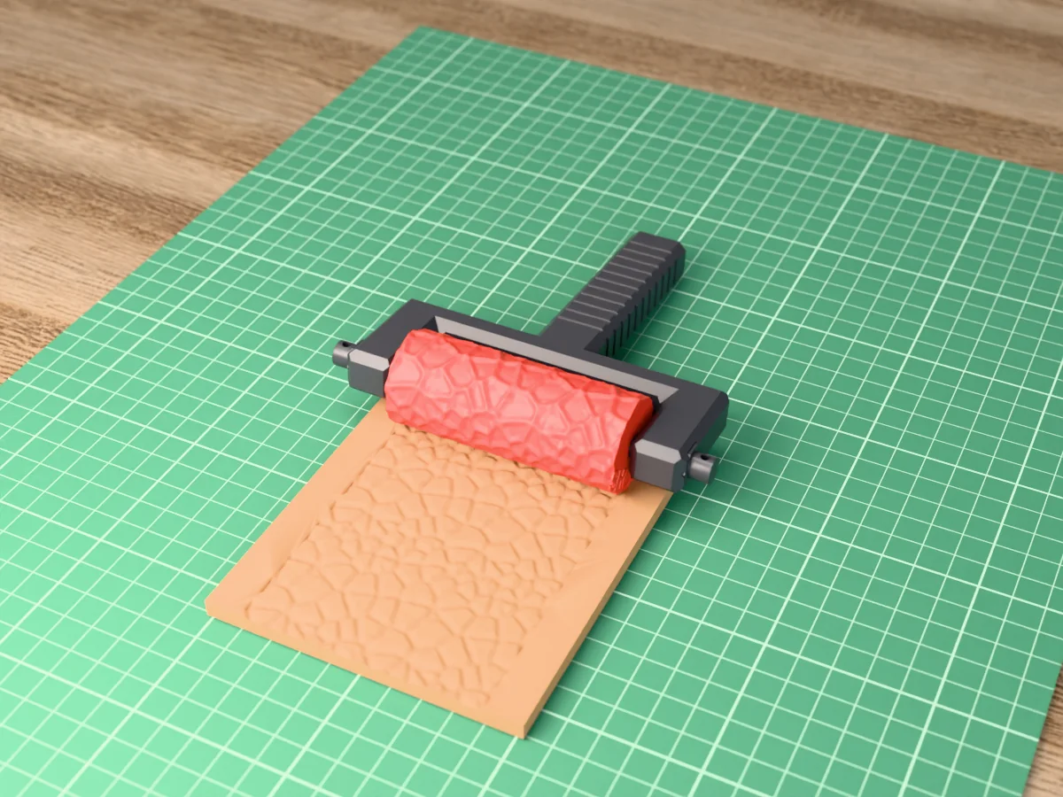 3D render of the printed cracked earth texture roller in its dark fork handle, resting on a slab of clay it has pressed with cracked dry earth
