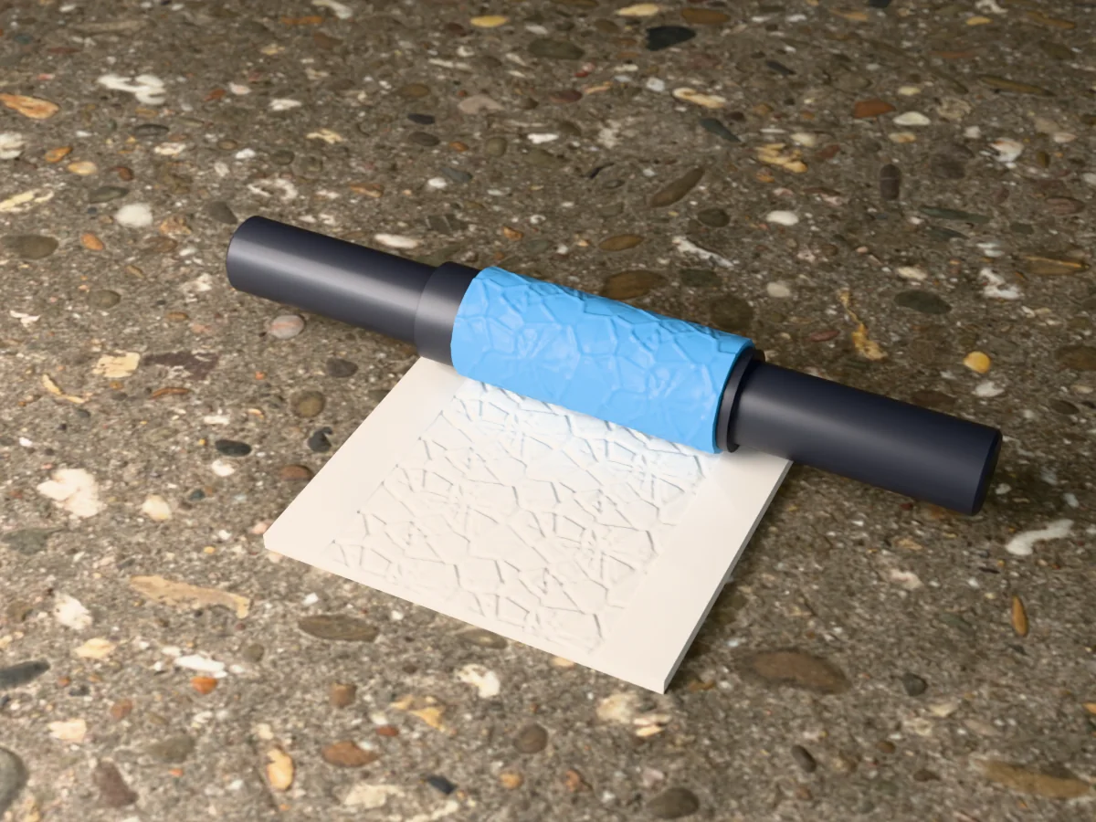 3D render of the printed cracked ice textured rolling pin, its patterned sleeve between two dark handles, resting on a slab of clay it has pressed with cracked ice floes