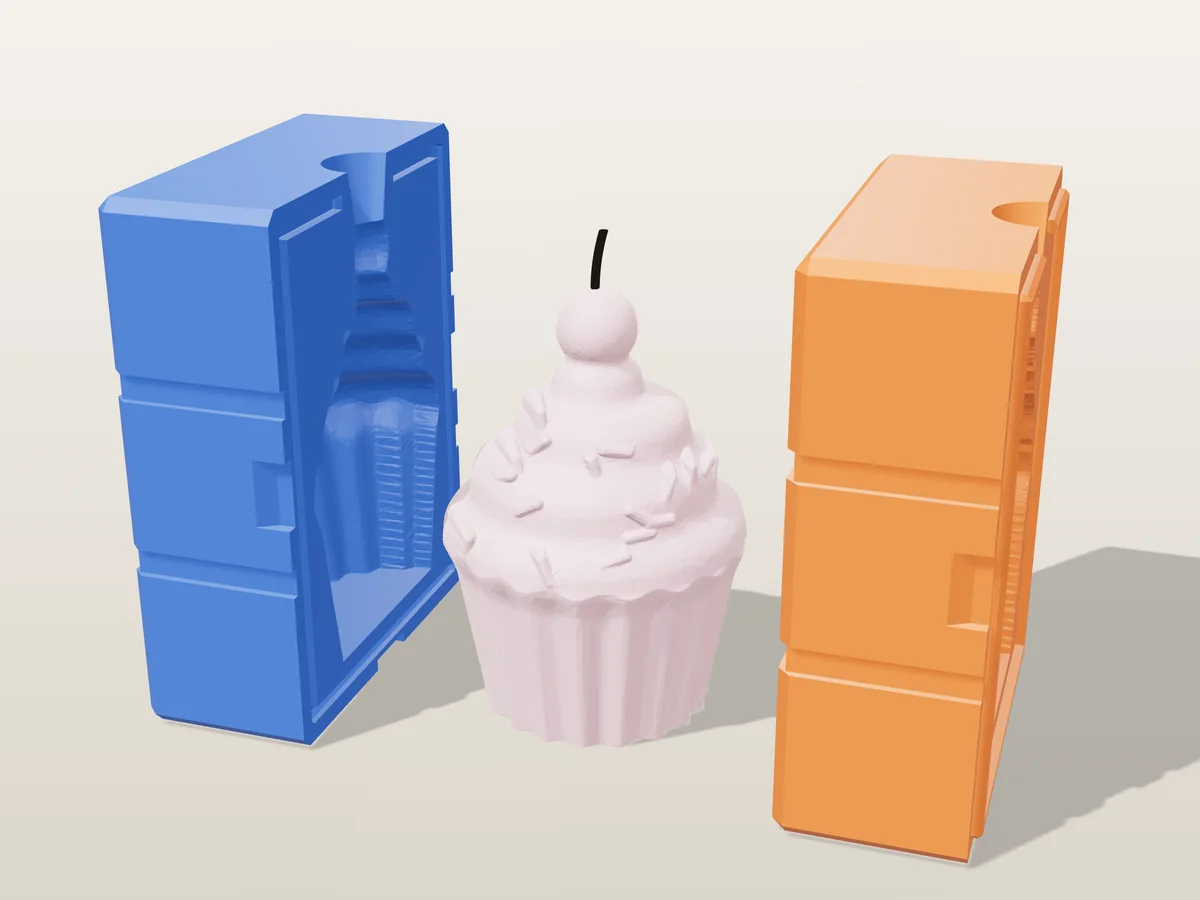 3D render of a pink cupcake candle with frosting swirls, sprinkles and a cherry between the two printed halves of its rigid blue and orange mold