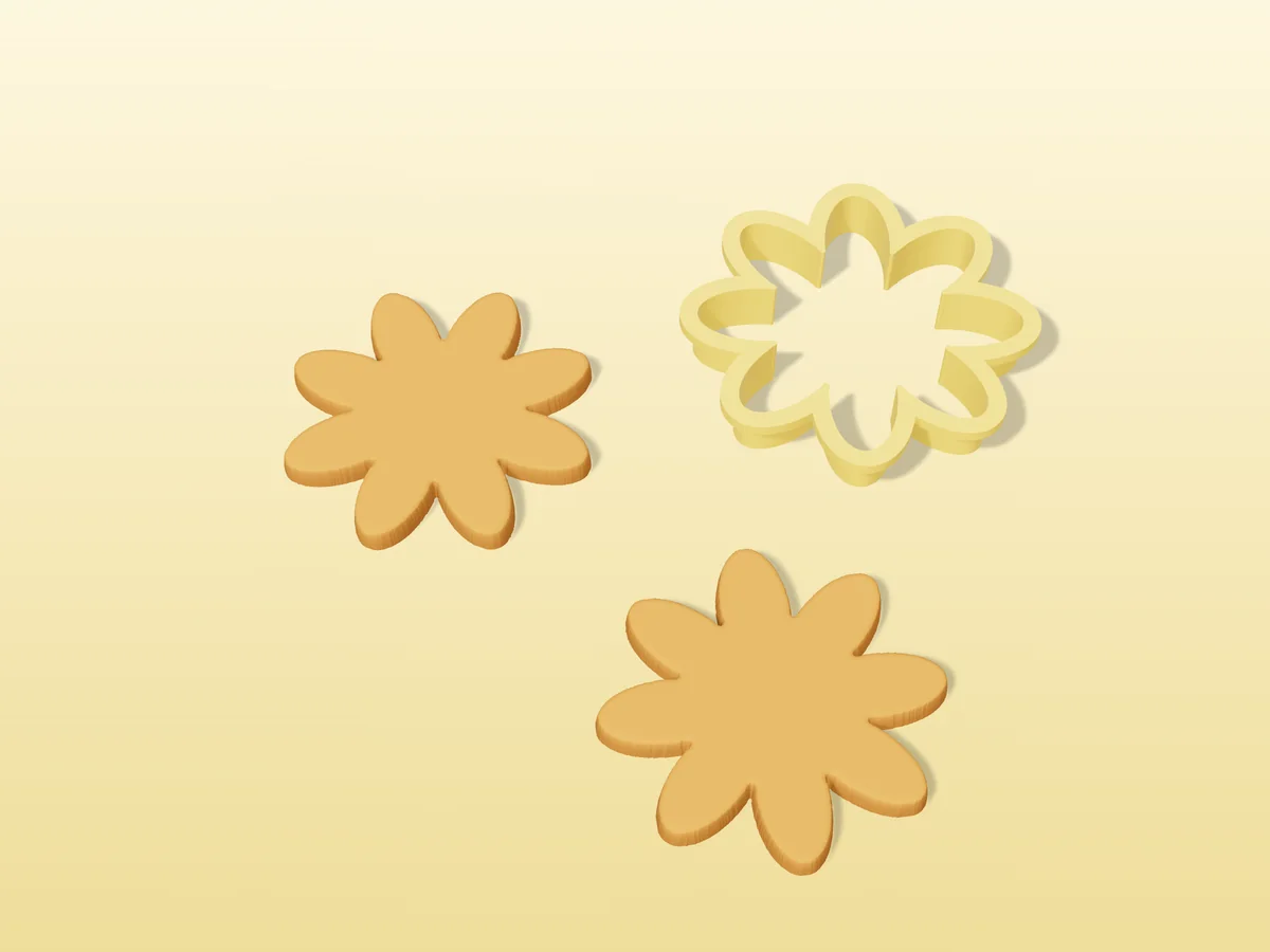 3D render of a yellow 3D-printed daisy flower cookie cutter next to two golden baked cookies in the same shape