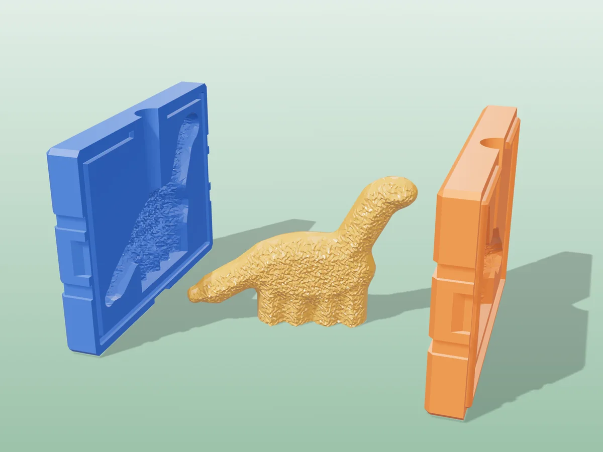 3D render of a golden breaded dinosaur nugget soap between the two printed halves of its rigid blue and orange mold