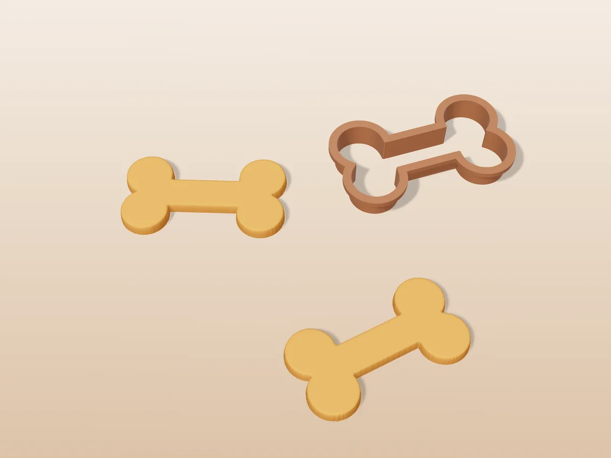 3D render of a brown 3D-printed dog bone cookie cutter next to two golden baked cookies in the same shape