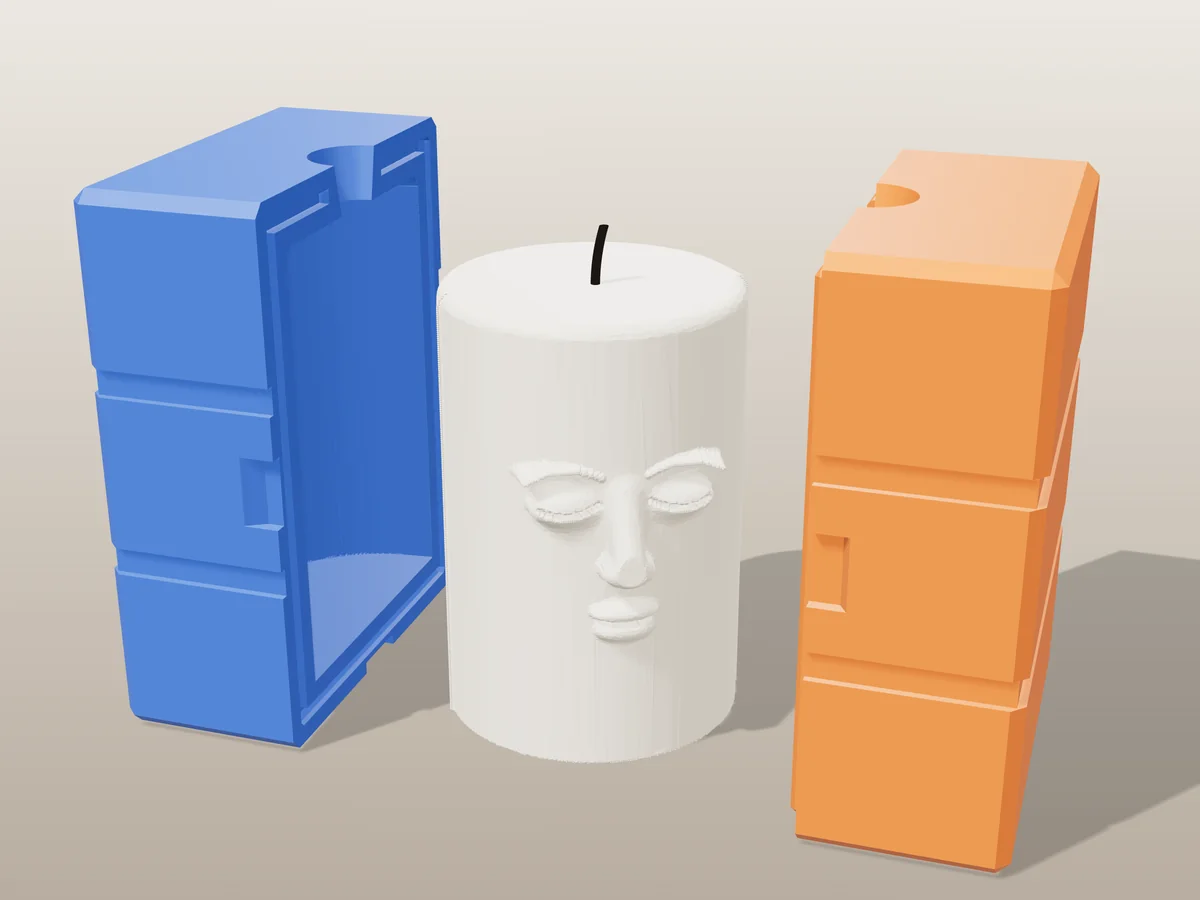 3D render of a cream pillar candle with a sleeping face in relief between the two printed halves of its rigid blue and orange mold