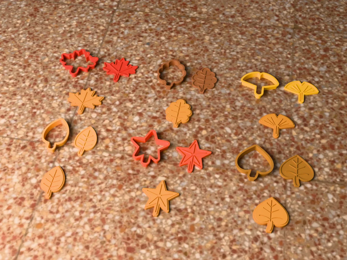 3D render of six 3D-printed fall leaves cookie cutters with their stamps and a golden stamped cookie in front of each: maple leaf, oak leaf, ginkgo leaf, birch leaf, sweetgum leaf and linden leaf