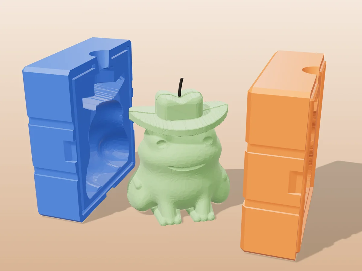 3D render of a green frog candle wearing a cowboy hat between the two printed halves of its rigid blue and orange mold