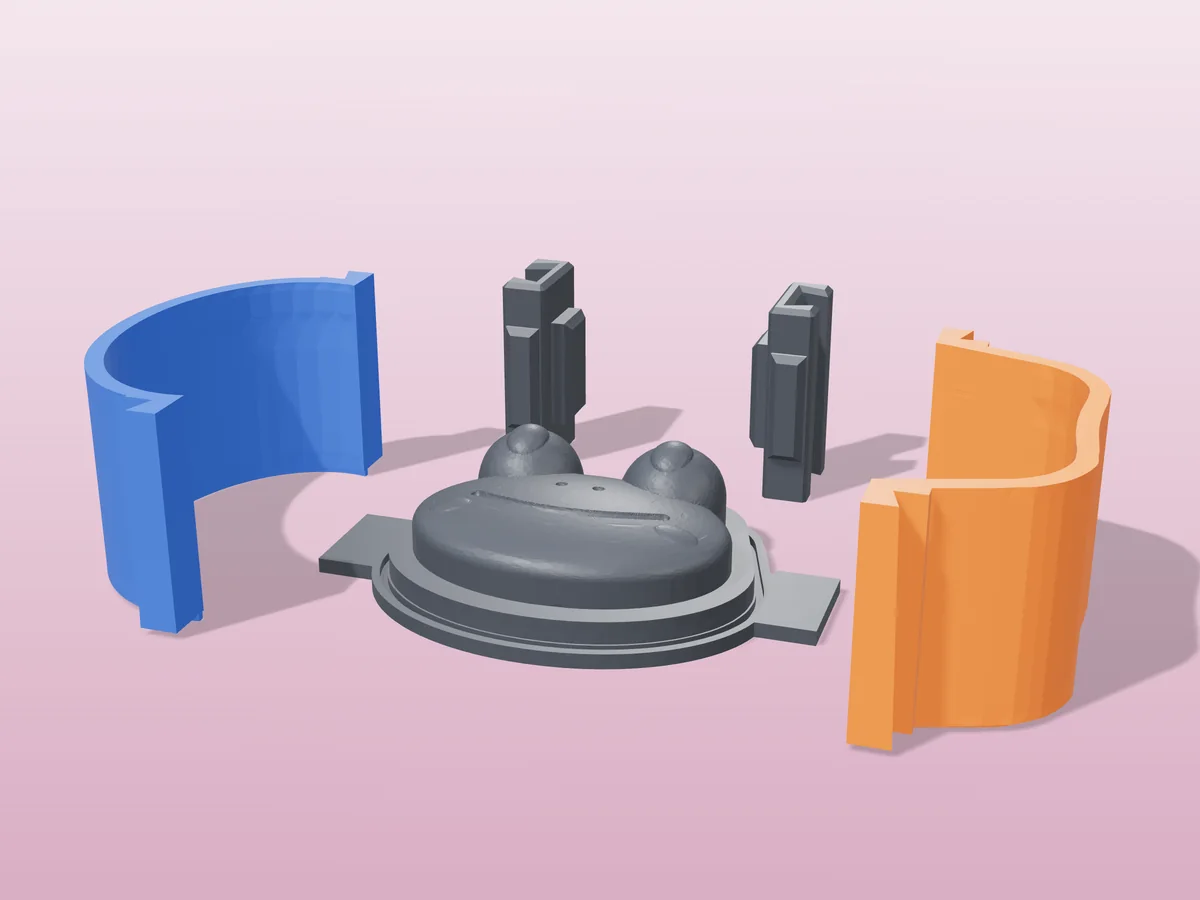 3D render of the frog face soap master fused on its printed charcoal base, between the orange and blue walls, with the charcoal clamps behind
