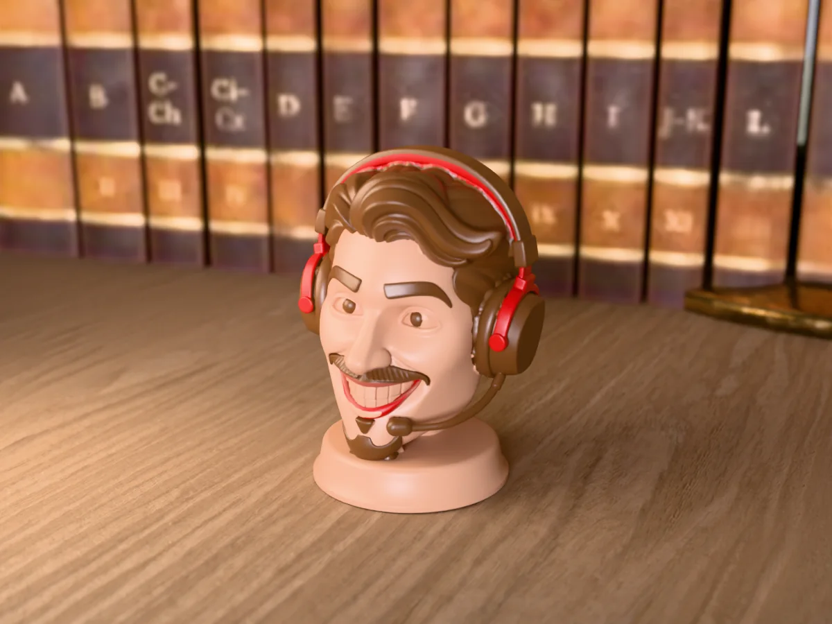 3D render of a 3D-printed bust of a grinning gamer in a red and black headset with a mic, painted in 6 colours, on a table