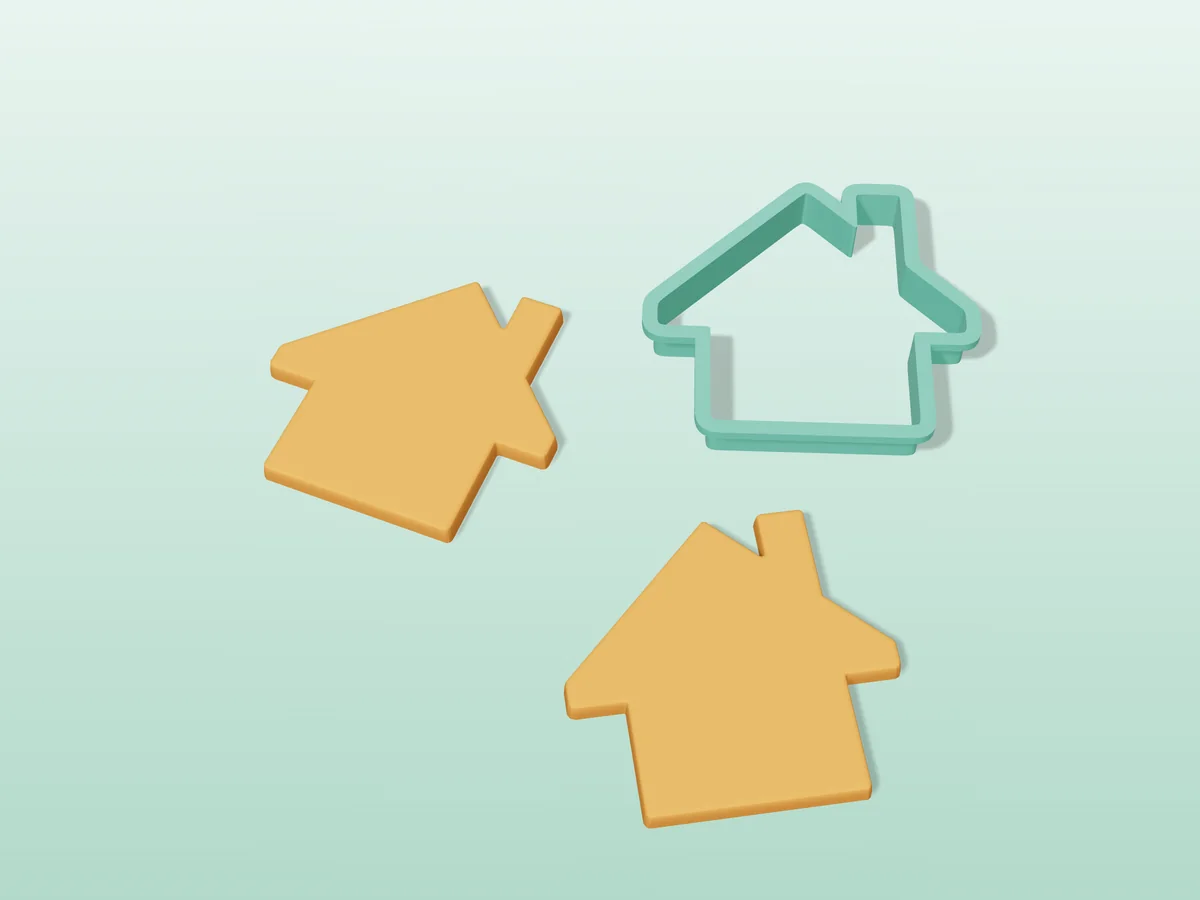3D render of a teal green 3D-printed gingerbread house cookie cutter next to two golden baked cookies in the same shape