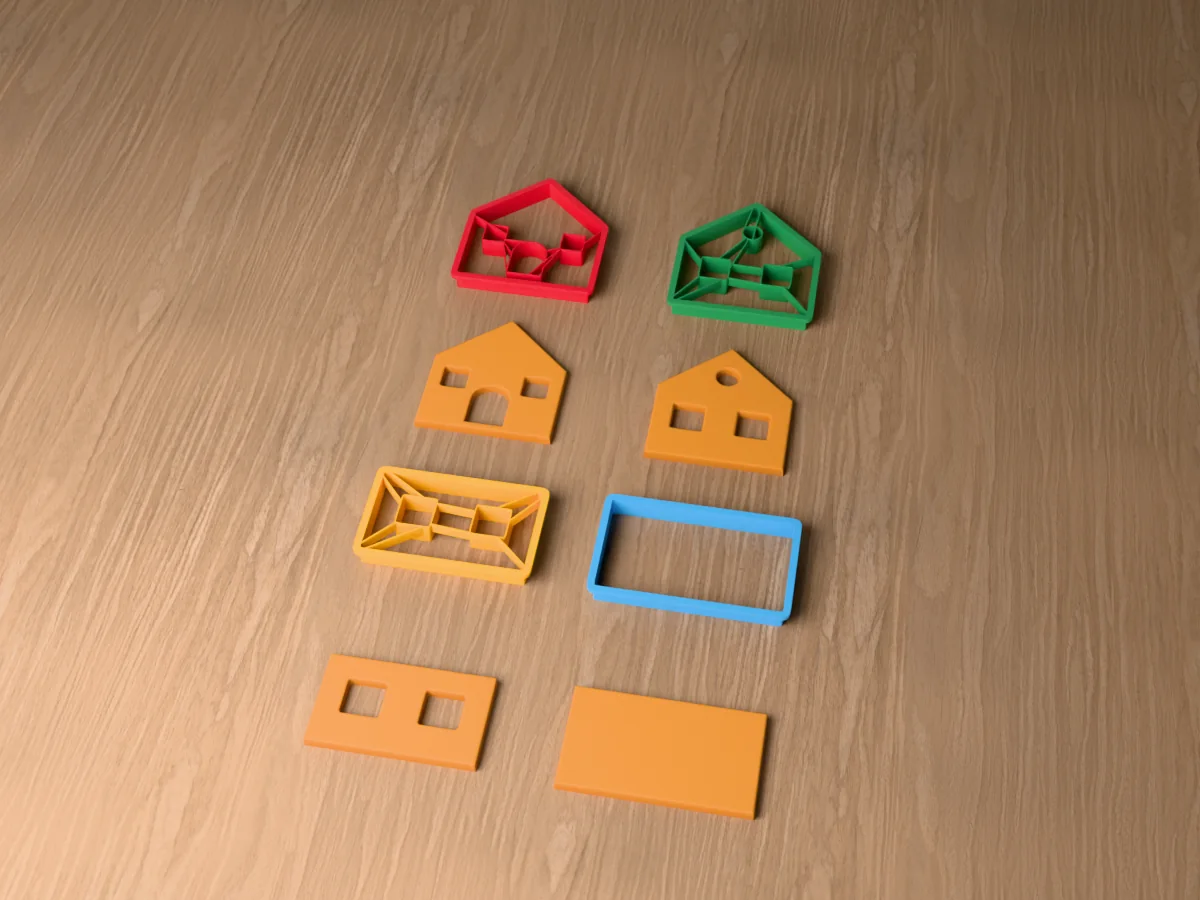 3D render of four 3D-printed gingerbread house cutters with a baked panel in front of each: front wall with door and windows, back wall with windows, side wall with windows and roof panel