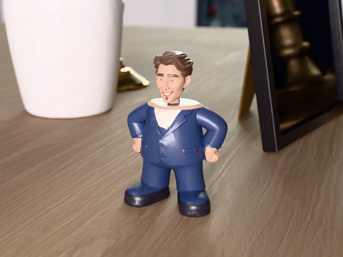 3D render of a 3D-printed mini figure of a guy with swept-back brown hair and a goatee, painted in 6 colours, on a table