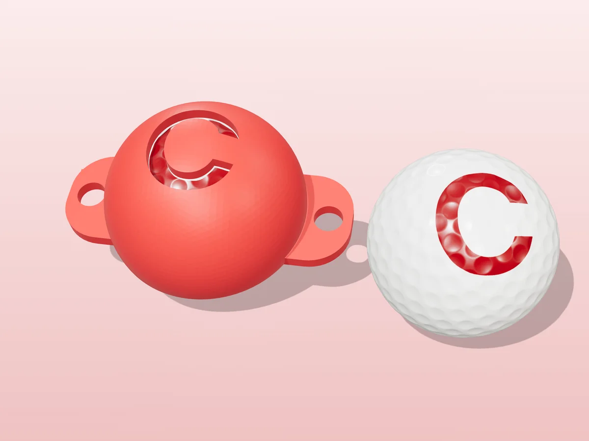 3D render of a red 3D-printed golf ball stencil with the letter C cut through it, sitting on a golf ball, next to a ball marked with a red C