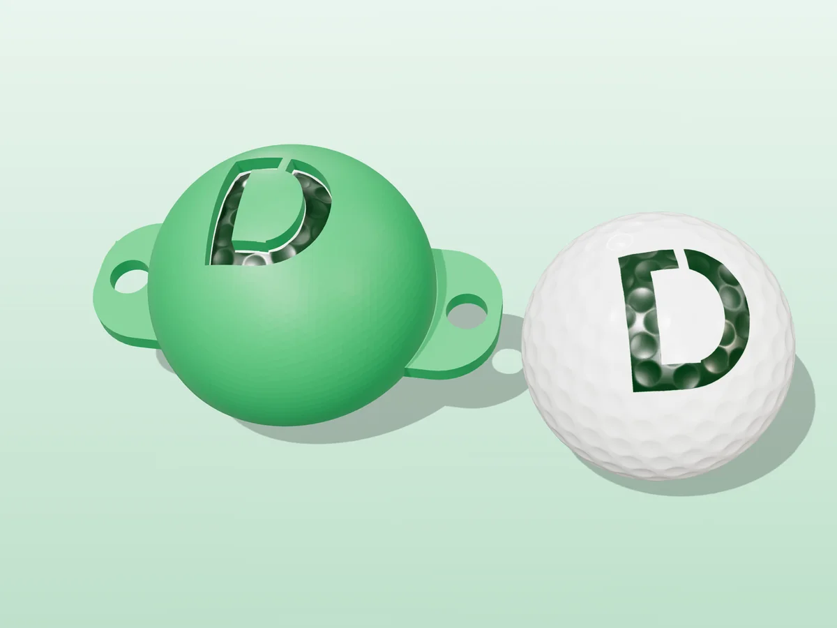 3D render of a green 3D-printed golf ball stencil with the letter D cut through it, sitting on a golf ball, next to a ball marked with a green D
