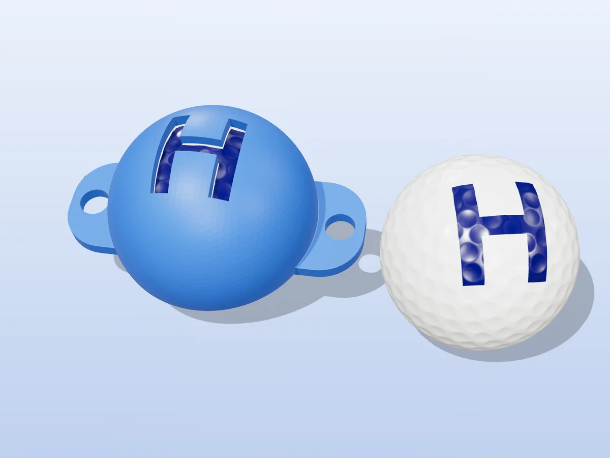 3D render of a blue 3D-printed golf ball stencil with the letter H cut through it, sitting on a golf ball, next to a ball marked with a blue H
