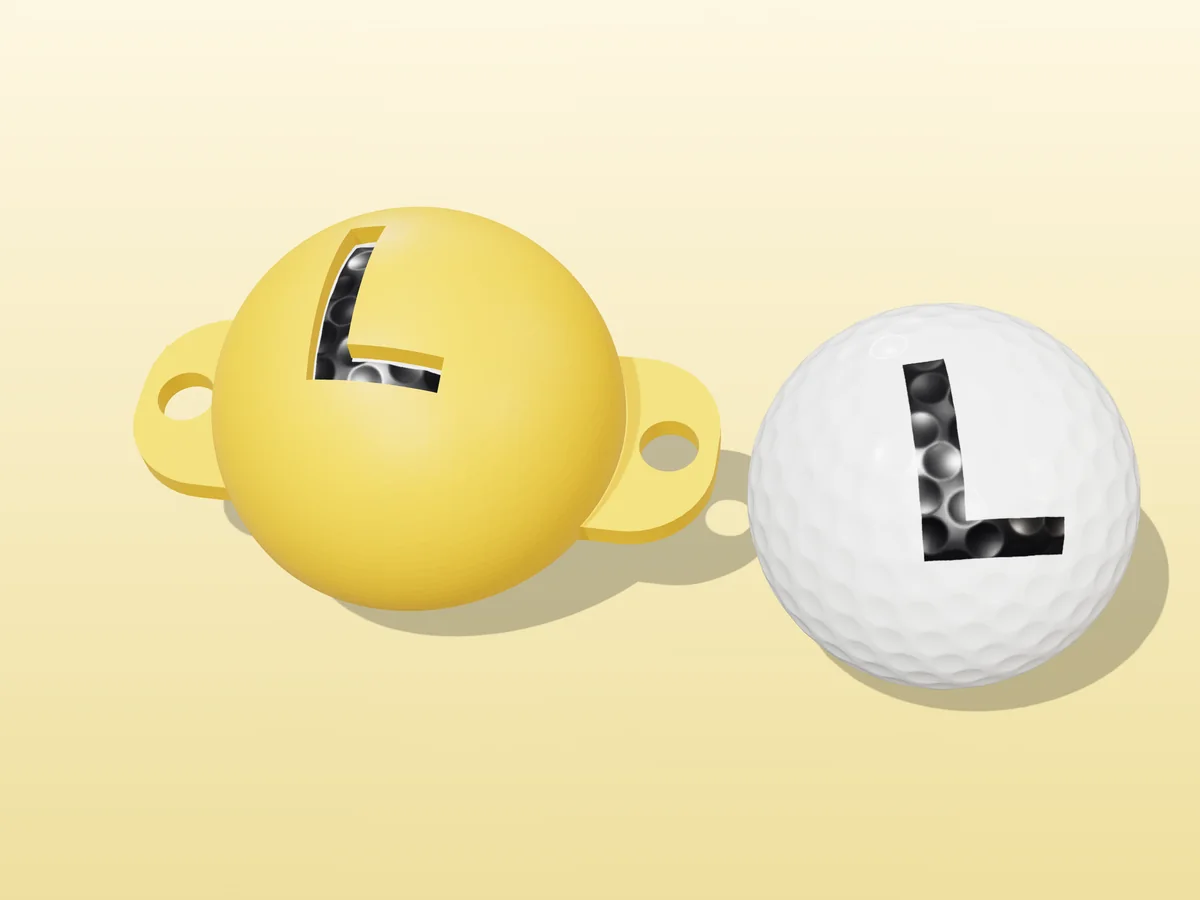 3D render of a yellow 3D-printed golf ball stencil with the letter L cut through it, sitting on a golf ball, next to a ball marked with a black L