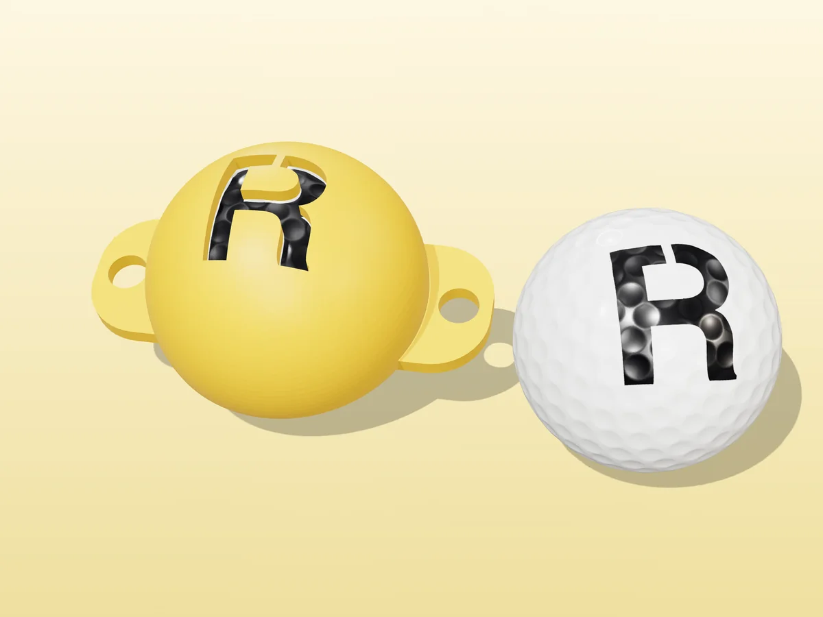 3D render of a yellow 3D-printed golf ball stencil with the letter R cut through it, sitting on a golf ball, next to a ball marked with a black R