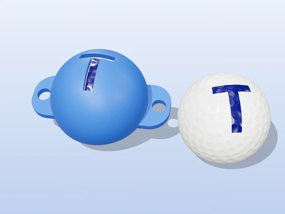 3D render of a blue 3D-printed golf ball stencil with the letter T cut through it, sitting on a golf ball, next to a ball marked with a blue T